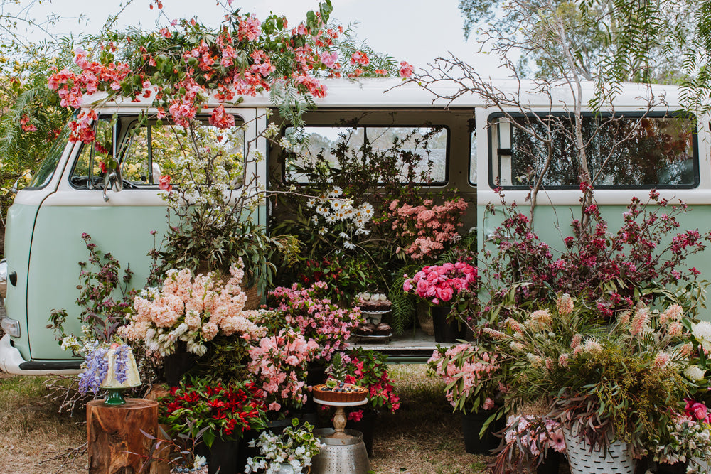 Vintage flower delivery van with bunches of beautiful bouquets